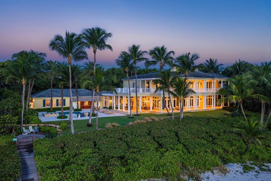 This gated estate is perfectly positioned on over two acres of prized Ocean-to-Intracoastal property along prestigious Hillsboro Mile. One of the largest parcels on Hillsboro Beach with an intercoastal guest house. This exceptional residence offers 200ft on both the Atlantic Ocean and 200ft of sheltered dockage on the intercoastal waterway. Privacy, security, and garden and water views from nearly every room.
Inspired by classic Bermuda architecture, the main residence is situated directly on the ocean and features a four-car garage, private fitness studio, elegant clubroom, and a stunning chef's kitchen with a walk-in pantry. Soaring ceilings and sun-drenched interiors create an effortless flow to the outdoor living areas, where an expansive pool terrace awaits. The second-level primary suite is a private retreat with captivating ocean vistas, separate sitting areas, and luxurious spa-like amenities. Additional guest suites, each with its own bath, provide comfort and privacy for family and visitors.
Across the estate, along the Intracoastal, you'll find 200 feet of prime waterfrontage, an additional pool, and a separate guest house complete with its own two-car garage. Ideal for yachting enthusiasts, the property's western waterfront offers convenient dockage and effortless access to the ocean. This beautiful estate also offers a private beach and is situated in a no-wake zone.
An extraordinary opportunity to own a landmark property in one of South Florida's most coveted coastal enclaves.