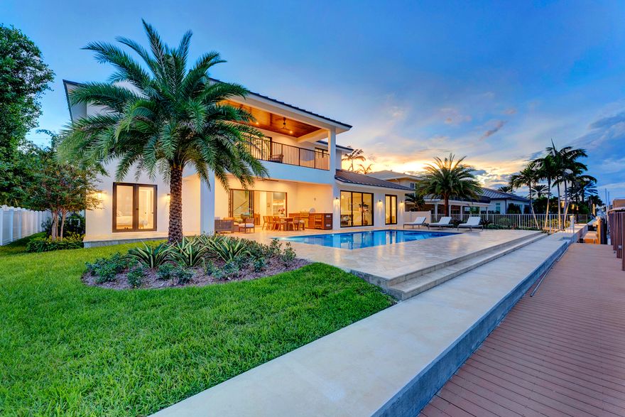 3205 Beacon Street blends timeless luxury with refined modern detail. Tucked away in the prestigious Hillsboro Shores community, the home sits on a wide, deep-water canal just minutes from the Hillsboro Inlet and Atlantic Ocean, north of the 14th Street drawbridge. With private beach access only minutes away, the home curates a South Florida lifestyle defined by elegance, leisure, and effortless connection to both land and water. Step inside and be immediately drawn to the open-concept design that frames sweeping waterfront views from the foyer. Soaring ceilings, natural light, and thoughtfully crafted interiors by Jessie DeAngelo Studio create a warm sophistication throughout its 5 bedrooms, 4.5 bathrooms, and 3,858 square feet of living space. The gourmet kitchen invites both gathering and culinary exploration. A large free-standing island anchors the space, complimented by premium stainless steel appliances by Jenn-Air, natural gas cooking, and exquisite millwork. 

Floor-to-ceiling windows illuminate the adjoining dining room and family rooms defining open-concept living. The first floor offers versatile living, including an en-suite guest room with private outdoor access to the heated saltwater pool and chic wet bar complete with sink and beverage refrigerator. Two additional bedrooms on the east wing with a shared bathroom that can easily be converted to en-suites. Ascend the light oak staircaseor take the elevatorto the second floor, where a spacious loft with dedicated office space leads to the serene primary suite. Here, a private balcony overlooks the water, offering the perfect setting for morning coffee or evening reflection. Dual custom walk-in closets provide artful organization, while the spa-inspired bath features a soaking tub, expansive rain shower, and dual vanities with a dedicated makeup vanity that redefine daily indulgence. 

Two sets of sliding glass doors open onto the resort-style elevated outdoor living with an oversized covered patio finished with custom ceiling paneling and recessed lighting.

A heated saltwater pool with tanning ledge and travertine decking coupled with  the summer kitchen with built-in grill and refrigeration perfect for al fresco dining creating a space defined by refined luxury. The property boasts 83 feet of water frontage and a newly constructed 73 foot PVC dock with electric and water guaranteeing seamless access to the Intracoastal waterway perfect for boating enthusiasts. 

Practical luxury is found at every turn: a 2-car epoxy garage with hurricane-rated doors, a circular driveway with room for six additional vehicles, a whole-home generator, motorized shades, tankless water heater, custom storage throughout, and security cameras for peace of mind. Perfectly positioned near fine dining, pristine beaches, and private aviation, 3205 Beacon Street is more than a homeit's a lifestyle. Why wait to own your slice of paradise?