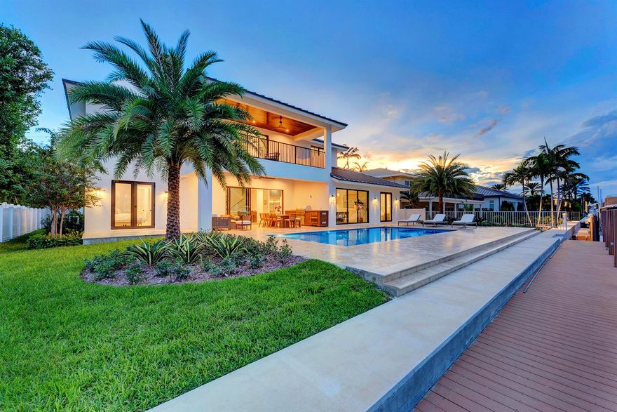 3205 Beacon Street blends timeless luxury with refined modern detail. Tucked away in the prestigious Hillsboro Shores community, the home sits on a wide, deep-water canal just minutes from the Hillsboro Inlet and Atlantic Ocean, north of the 14th Street drawbridge. With private beach access only minutes away, the home curates a South Florida lifestyle defined by elegance, leisure, and effortless connection to both land and water. Step inside and be immediately drawn to the open-concept design that frames sweeping waterfront views from the foyer. Soaring ceilings, natural light, and thoughtfully crafted interiors by Jessie DeAngelo Studio create a warm sophistication throughout its 5 bedrooms, 4.5 bathrooms, and 3,858 square feet of living space.