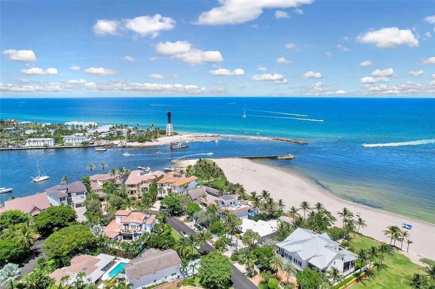 Enjoy gated private beach access. 3205 Beacon Street blends timeless luxury with refined modern detail. Tucked away in the prestigious Hillsboro Shores community, the home sits on a wide, deep-water canal just minutes from the Hillsboro Inlet and Atlantic Ocean, north of the 14th Street drawbridge. With private beach access only minutes away, the home curates a South Florida lifestyle defined by elegance, leisure, and effortless connection to both land and water. Step inside and be immediately drawn to the open-concept design that frames sweeping waterfront views from the foyer. Soaring ceilings, natural light, and thoughtfully crafted interiors by Jessie DeAngelo Studio create a warm sophistication throughout its 5 bedrooms, 4.5 bathrooms, and 3,858 square feet of living space. The gourmet kitchen invites both gathering and culinary exploration. A large free-standing island anchors the space, complimented by premium stainless steel appliances by Jenn-Air, natural gas cooking, and exquisite millwork.   Floor-to-ceiling windows illuminate the adjoining dining room and family rooms defining open-concept living. The first floor offers versatile living, including an en-suite guest room with private outdoor access to the heated saltwater pool and chic wet bar complete with sink and beverage refrigerator. Two additional bedrooms on the east wing with a shared bathroom that can easily be converted to en-suites. Ascend the light oak staircase or take the elevator to the second floor, where a spacious loft with dedicated office space leads to the serene primary suite. Here, a private balcony overlooks the water, offering the perfect setting for morning coffee or evening reflection. Dual custom walk-in closets provide artful organization, while the spa-inspired bath features a soaking tub, expansive rain shower, and dual vanities with a dedicated makeup vanity that redefine daily indulgence.   Two sets of sliding glass doors open onto the resort-style elevated outdoor living with an oversized covered patio finished with custom ceiling paneling and recessed lighting.  A heated saltwater pool with tanning ledge and travertine decking coupled with  the summer kitchen with built-in grill and refrigeration perfect for al fresco dining creating a space defined by refined luxury. The property boasts 83 feet of water frontage and a newly constructed 73 foot PVC dock with electric and water guaranteeing seamless access to the Intracoastal waterway  perfect for boating enthusiasts.   Practical luxury is found at every turn: a 2-car epoxy garage with hurricane-rated doors, a circular driveway with room for six additional vehicles, a whole-home generator, motorized shades, tankless water heater, custom storage throughout, and security cameras for peace of mind. Perfectly positioned near fine dining, pristine beaches, and private aviation, 3205 Beacon Street is more than a home it's a lifestyle. Why wait to own your slice of paradise?