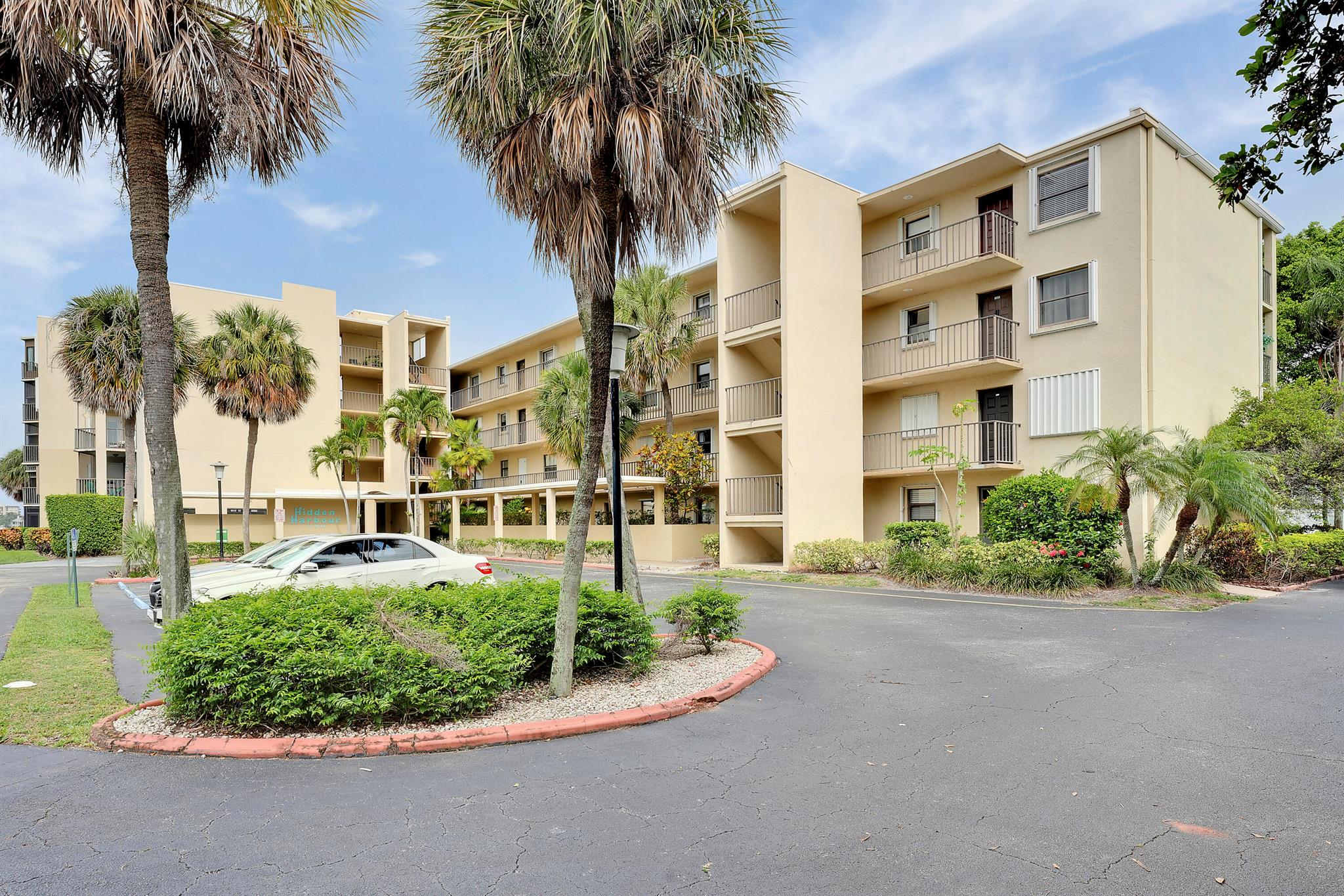 Welcome to this beautiful 2 bedroom, 2 full bathroom condo for rent in the gated intracoastal community of Hidden Harbour. Freshly painted bedrooms, spacious living room, and a screened patio with a peaceful water view. The primary bedroom features a walk-in closet, large bathroom, and direct patio access. Split floor plan offers added privacy. Washer and dryer included for your convenience. The community offers fantastic amenities including a resort-style pool, clubhouse, fitness center, sauna, library, game room, and more--all just minutes from the beach, shopping, and dining!