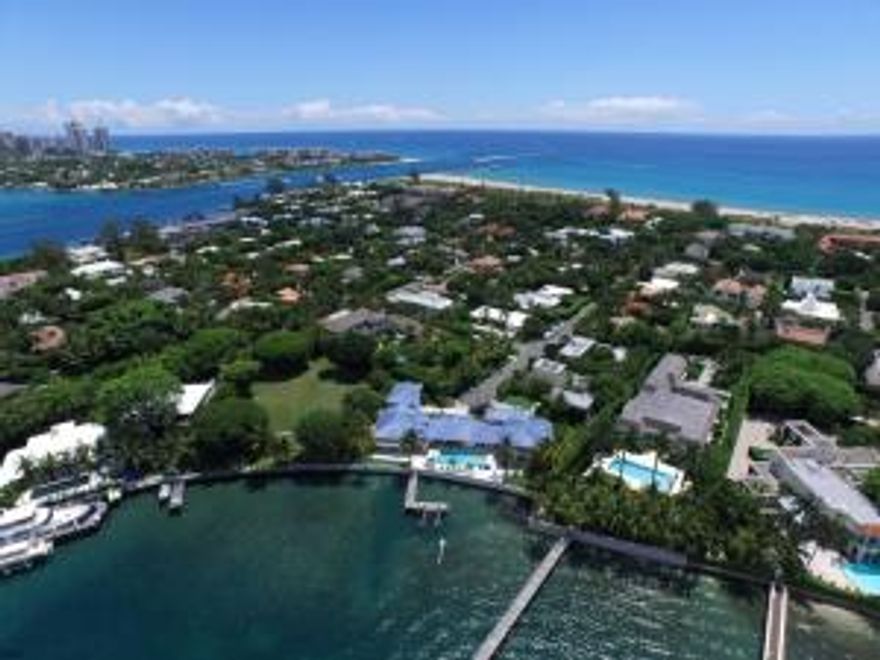 Direct Intracoastal Estate with 163' of water frontage. Stunning panoramic views. Boaters paradise with Intracoastal dock with boat lift and nearby Ocean access. Features include great room with 14' coffered ceilings, theater room, wine room, sunken bar, exercise room and lighted racquetball court. Great opportunity to renovate or build your 9,000 +/- square foot lakefront estate.