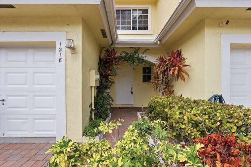 Welcome to 1218 Imperial Lake Drive, West Palm Beach, FL 33413, a beautifully remodeled waterfront townhome offering elegance, comfort, and stunning lake views. This move-in-ready home features tile flooring throughout, a fully upgraded kitchen with newer cabinetry, stainless steel appliances, and a spacious eat-in bar perfect for entertaining while enjoying peaceful water views.

The bright and spacious living and family room showcases large windows and sliding glass doors overlooking the lake. Both bathrooms have been tastefully renovated, including a luxurious primary bathroom with a modern walk-in shower. The primary suite also offers a large walk-in closet with custom California Closet built-ins.Step outside to a private backyard with charming white picket fencing -- ideal for relax