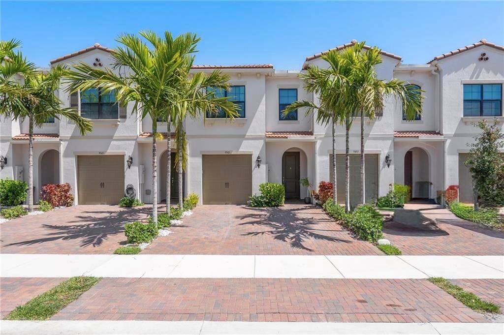 Modern townhouse located in the desirable gated community of Enclave in Boca Raton. This 3-bedroom, 2.5-bath home features a stunning chef's kitchen with white shaker cabinets, quartz countertops, and stainless steel appliances. The open-concept floor plan with volume ceilings is ideal for entertaining family and friends. The spacious owner's suite includes a custom walk-in closet & a luxurious en-suite bath with an oversized frameless glass shower. This home is loaded with designer touches, including custom light fixtures, ceiling fans, and recessed lighting throughout. The convenient second-floor laundry room offers a wash sink and additional storage. Full hurricane protection with impact glass throughout. Enjoy resort-style community amenities such as a clubhouse, fitness center & pool