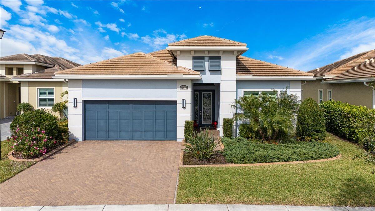 Welcome to this fabulous and meticulously maintained home, offering 2 BR + den, easily converts to 3rd BR, 2BA. Decorative glass entry door. Top-of-the-line off-white kitchen cabinetry, cook top and enhanced hood, wall ovens, stunning granite countertops complemented by glass tile backsplash, SS appliances, custom walk-in pantry completes this chef's dream kitchen. Plenty of crown molding, plantation shutters, stylish light fixtures & fans throughout. The bathrooms are equipped with wood-look tile floors, large laundry room includes sink,additional cabinetry.Durable epoxy flooring in garage. Lush landscaping and custom curbing.Enjoy the large lanai and beautiful lake views. Impact glass and a storm smart hurricane remote screen.This home truly has it all!