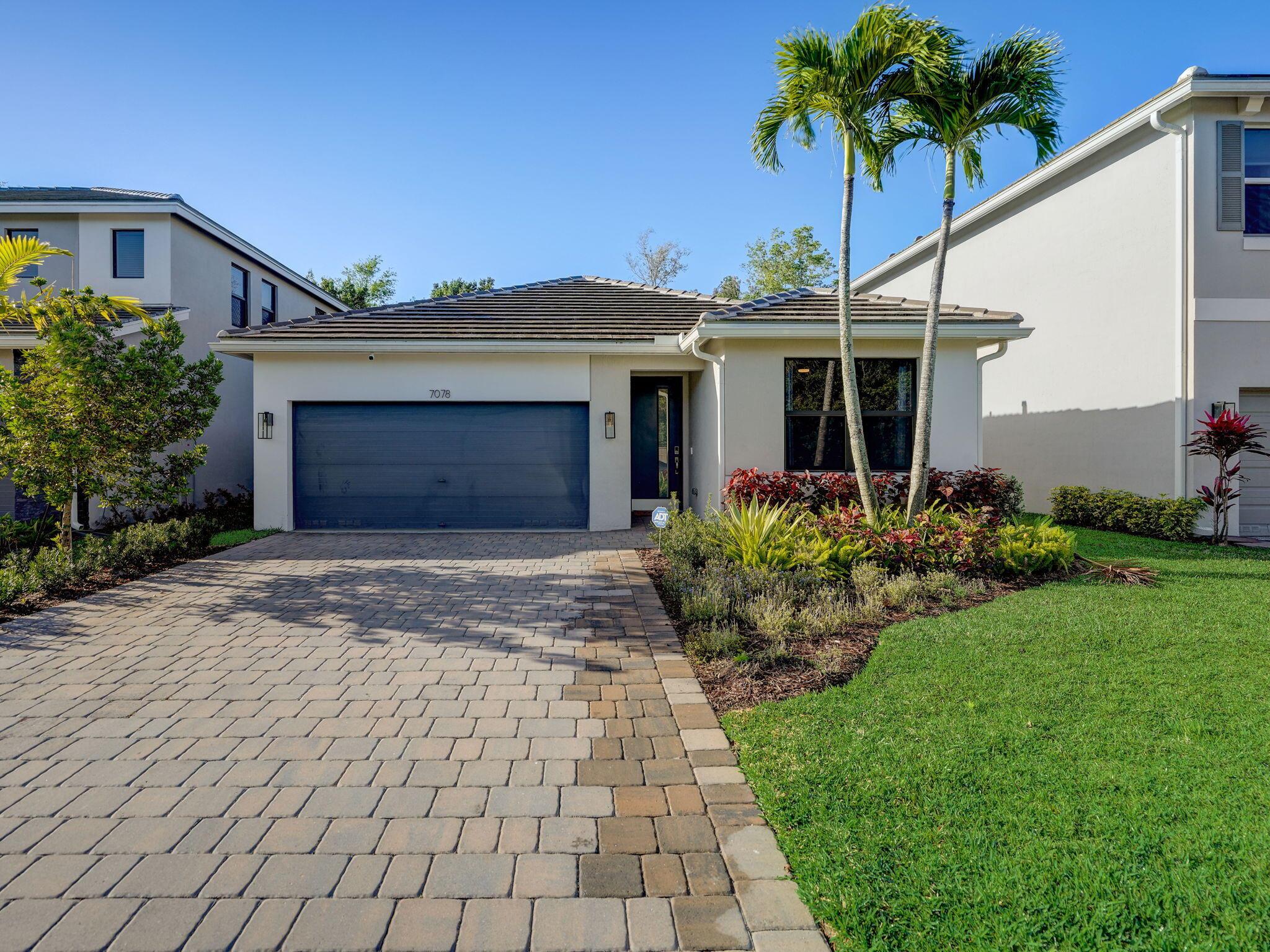 Welcome to your dream home in Jupiter's newest gated community! This stunning property boasts a modern chic design with upgraded light fixtures and custom details throughout. With three bedrooms plus a flex room that could easily serve as a fourth bedroom, this home offers versatility and space for all your needs. As you step inside, you'll be greeted by a spacious open floor plan with volume ceilings that create an airy and inviting atmosphere. The open kitchen is perfect for entertaining, featuring sleek countertops, stainless steel appliances, and ample cabinet space. The large master suite is a true retreat, complete with a custom built-in closet for all your storage needs. Come see for yourself! Extras include gutters, flood lights, alarm system, coated garage floor, and more...