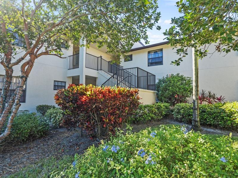 Gorgeous updated 2nd floor condo with 2 bedrooms, a den/office and 2 full bathrooms. Beautifully renovated eat-in kitchen with white kitchen cabinets, granite counters and tile backsplash open to the dining and living areas. Master suite includes a renovated bathroom with a large vanity, 2 sinks and granite counters, a separate tub and a shower with seamless glass door and a walk-in closet. This ready to move-in corner unit features high ceilings, large plank wood laminate floors in the living areas and master bedroom, wiring for speakers, a separate laundry room with washer and dryer, a screened patio with sliding acrylic panels overlooking a golf course, accordion shutters on all windows with hurricane panels on sliding doors. Sold turnkey and ready to move in. 55+ community.
