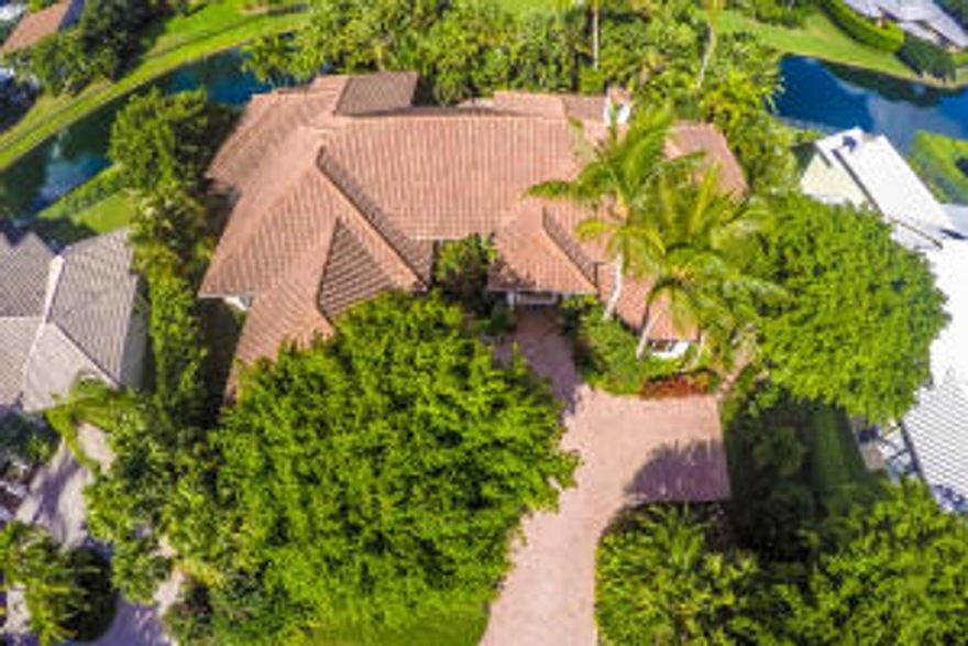 A tropical paradise nestled in prestigious Palm Beach Polo Golf & Country Club. Golf membership is not mandatory. This custom estate home boasts 5BR, 5.5BA with an open design ideal for entertaining.  The stone and wood mantel fireplace in the living room with its soaring ceilings and French doors open the home to the lush professional landscape and the salt water heated pool.  The kitchen with its Limoges French porcelain knobs are one of the many custom intricate features throughout this home.  The floor plan is exceptional for house guests with all bedroom windows dressed with plantation shutters.  Crown moldings, unique window panels, marble and wood flooring give this house its old world charm.  A gem right in the heart of one of Wellington's finest developments.