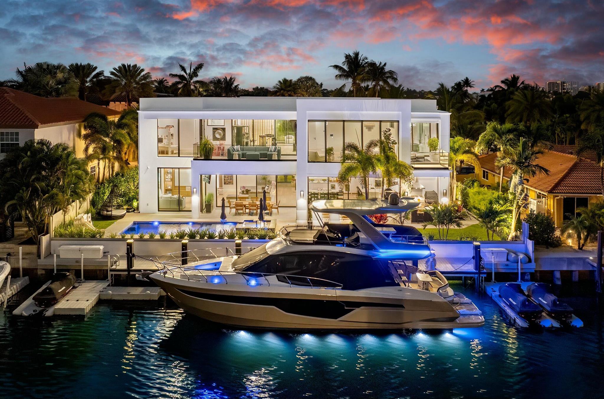 Villa Mariner, nestled along the tranquil shores of a wide, deep-water, canal just off the Intracoastal Waterway, 772 Glouchester Street in Boca Raton is a true masterpiece of contemporary design. Completed in April 2024, this two-story residence blends world-class amenities with sophisticated architecture, offering a luxurious waterfront sanctuary where elegance meets innovation. Spanning 6,870 square feet, this estate features 5 bedrooms and 6 bathrooms, seamlessly integrating modern sophistication with cutting-edge smart home technology. A grand 23-foot atrium entry introduces a light-filled living space, where floor-to-ceiling windows frame stunning water views.