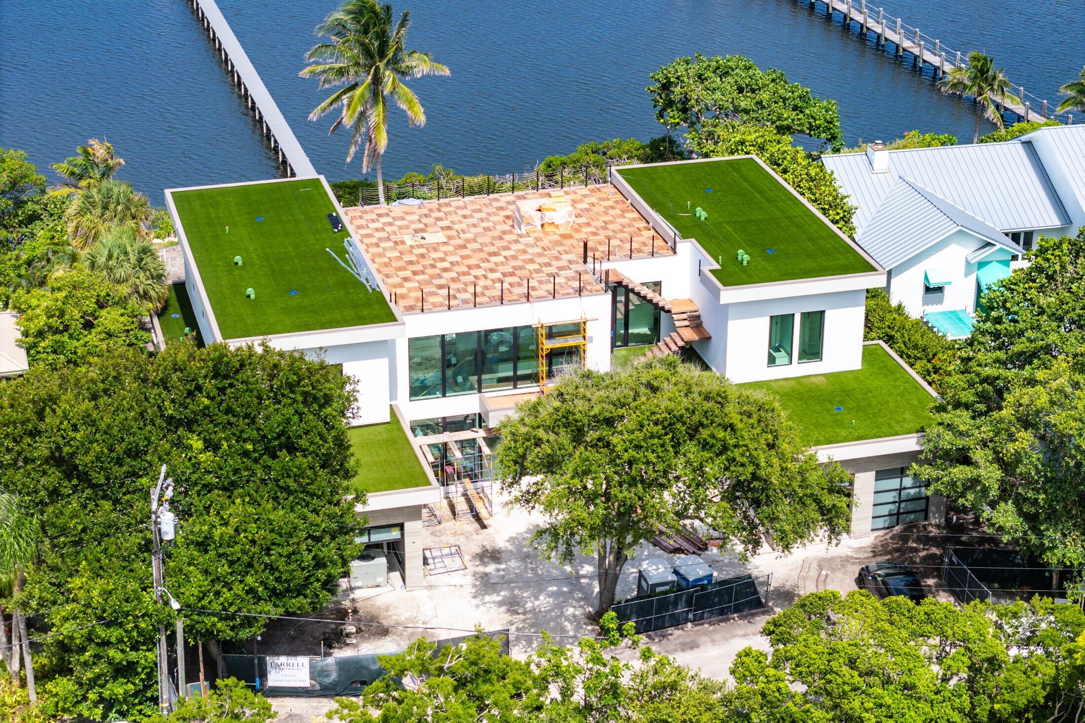 Magnificent Waterfront Estate on Hypoluxo Island by Farrell Building Company. Introducing an extraordinary opportunity to own one of the most prestigious homes ever to grace Hypoluxo Island. This exceptional waterfront estate, currently under construction by Farrell Building Company--one of the nation's most renowned ultra luxury builders--promises to redefine luxury living in South Florida. Set on a sprawling half-acre with 120 feet of direct water frontage, this masterpiece will offer unparalleled views of the pristine waterways and some of the finest estates in the world, including the coveted Manalapan Oceanfront Estate. Spanning over 7,800 square feet, this estate will feature 10-foot ceilings on both floors, creating a sense of grandeur and openness throughout the home. With seven