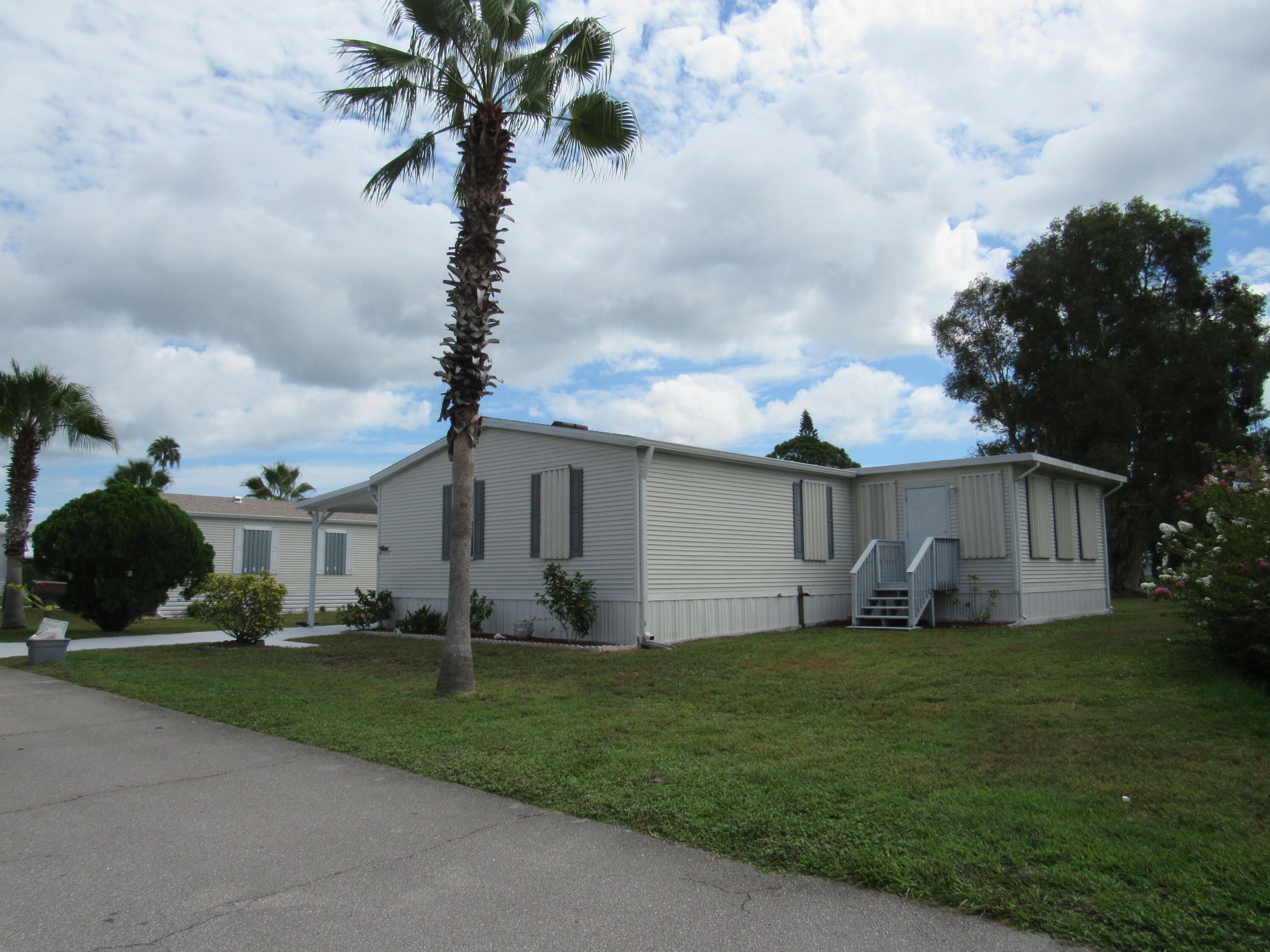2005 Palm Harbor mobile home with a large (12x20) Florida room located on the most sought after lot in Spanish Lakes One 55+ community. Enjoy the fantastic sunrise views all year long. A great place to relax and enjoy the peacefulness of your large backyard. Enjoy your morning coffee or evening glass of wine while while enjoying the cooling breeze by the lake. This home has a total of 1460 sq ft of living space. 2 Bedroom 2 Bath home with a large shed that can accommodate a golf cart. New roof 2023. The active 55+ community allows for resort style living at its best with OWNER FREE 9 HOLE GOLF, 2 pools, Land lease includes lawncare and trash pick up.
