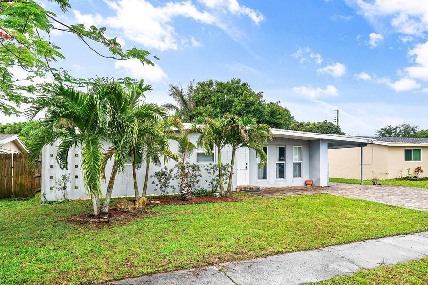 3-bedroom, 2-bath single-family home in Royal Palm Beach with no HOA. This one-story home offers a split-bedroom layout, great natural light, impact windows, and a spacious fenced backyard with plenty of room to enjoy or personalize. The kitchen features granite countertops, white cabinetry, and updated tile flooring. Seller improvements include an updated master bathroom, newer tile flooring in the kitchen and bedrooms, improved paver driveway, and interior/exterior paint. Covered carport and convenient location close to Commons Park, Veterans Park, shopping, dining, and everyday essentials. Sizes approximate; buyer to verify.