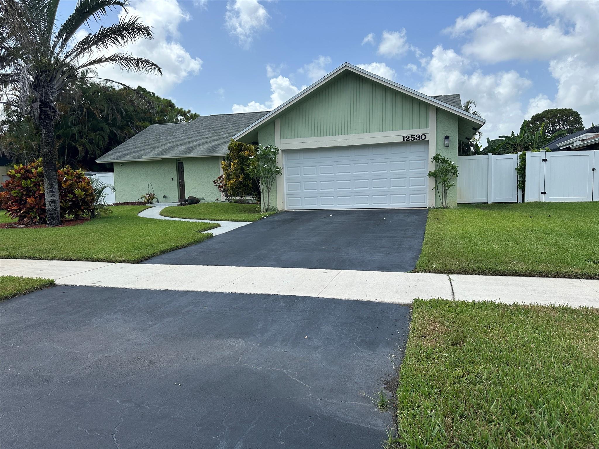 Welcome to your private oasis in the heart of Davie! This stunning 3-bedroom, 2-bathroom single-family home offers the perfect blend of comfort, style, and outdoor living, all with the added benefit of NO HOA. Step inside to discover a spacious 1,725 sq. ft. floor plan featuring a mix of cool tile and warm hardwood flooring. The heart of this home is its seamless flow from the living areas to your private backyard retreat. The expansive, private backyard is your personal paradise, featuring a large screened-in porch perfect for entertaining or enjoying a quiet evening. A convenient automatic sprinkler system keeps your lush surroundings green and vibrant year-round.