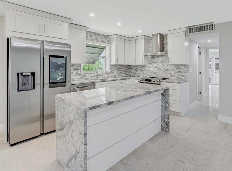 Welcome to this beautifully updated 2-bedroom & 2-bath ground floor condo in the desirable 55+ community of Kings Point in Delray Beach. This unit went through a full renovation, and it's like a new construction home. As you enter, you'll be greeted by an open and airy layout, featuring a spacious living area with abundant natural light. The custom-designed kitchen is a chef's dream, featuring brand new stainless-steel appliances, an oversized quartz island, and sleek tile backsplash. This gem boasts modern upgrades with brand new tile flooring throughout, AC, water heater, electrical panel, designer lighting fixtures, and deluxe closet systems. This condo includes two generously sized bedrooms and two full baths. The expansive and light-filled Florida