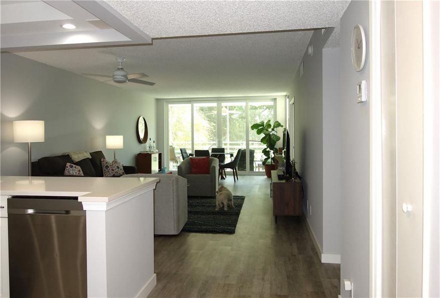 Beautiful and fully remodeled third floor two bedroom two bath condo with ALL IMPACT WINDOWS AND SLIDER! This wonderful home has been fully remodeled in 2019 featuring an open floorplan kitchen with quartz countertops and recessed lighting. Some of the many other upgrades include waterproof luxury vinyl flooring, new doors, ceiling fans, blinds and much more. The view from the screened balcony is spectacular. The master bathroom has been enlarged and has a full frosted glass door like you would see in a high end hotel. This is 5 star listing and should be put on any serious buyers list of homes to see. This is a pet friendly association. Association includes cable and internet, 2 heated pools, and is a great place walking.