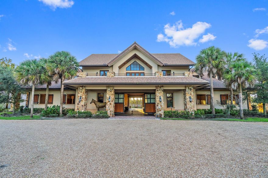 Discover Jupiter's hidden gem, perfect for privacy-seekers, nature lovers and equestrians alike. Seize the rare opportunity to build your custom dream home on this exquisite, ready-to-build property located inside Ranch Colony's Estate subdivision. Nestled between preserves this beautifully manicured 20-acre property is one of the driest lots available.  Enter this private property through gated entrance with tall hedges and down a winding 8'' reinforced concrete driveway through breathtaking landscape and beautiful ponds, bridge, and white sand 'beach'.Experience the pinnacle of equestrian luxury inside the main barn featuring 10 oversized 15' x 16' stalls.  This hurricane rated Show Barn is equipped with state-of-the-art features including: