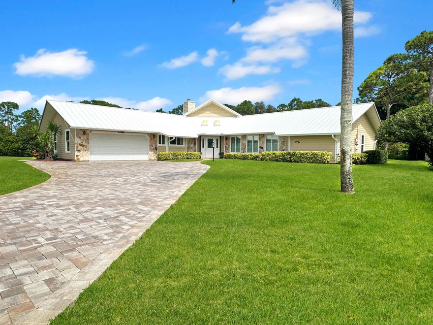 Nestled in a serene cul-de-sac amidst the charm of northern St Lucie County, this exquisite single-family residence boasts an expansive .61-acre lot, providing a private oasis for your family to thrive. Crafted with a sturdy frame construction, adorned with hardy-board siding, topped with a durable metal roof, this home offers the pinnacle of security with impact-resistant doors and windows throughout. The property greets you with an expanded brick paver driveway, leading to a welcoming entrance with double skylights. The interior has been meticulously cared for, featuring a brand-new A/C system complete with pristine duct work. Inside, the spacious kitchen is a chef's dream, showcasing rich wood cabinets, elegant granite countertops, and top-of-the-line stainless steel appliances. Entertain in style with a formal dining area accented by a sophisticated tray ceiling, and unwind in the large living room with a cozy fireplace and direct porch/pool access.  Family comfort is paramount with large guest bedrooms connected by a convenient Jack and Jill bath, while the master suite offers a luxurious retreat with dual sinks and a walk-in shower. A laundry room with ample storage and a convenient half bath further complement the living space.  Step outside to a large covered porch with sealed brick pavers, extending to an impeccable, screened, heated pool surrounded by elegant slate decking. This haven is ideal for year-round enjoyment and entertainment.  Located in a well-established neighborhood, your new home is minutes away from shopping, dining, quality schools, lush parks, golf courses, sun-kissed beaches, and major roadways, ensuring a perfect blend of tranquility and accessibility. Welcome to your dream family home, where every detail has been curated for your utmost comfort and delight