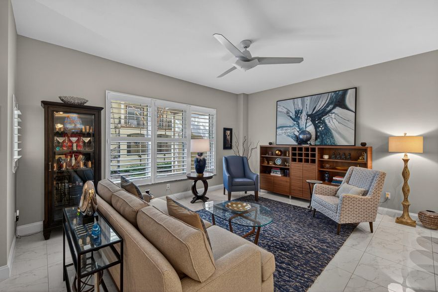 Beautifully appointed 2-bedroom plus den and boutique office, 2.5-bath townhome in gated Wilton Station, ideally set along the Main Promenade in desirable Village Lane. This two-story residence showcases elegant porcelain tile throughout, striking glass and cable railings, and a designer kitchen with quartz countertops, waterfall edge, and stainless steel appliances. Plantation shutters, custom closets, and two tastefully remodeled baths enhance the home's refined feel. The sunlit second bedroom features dual French doors, with private balconies off both bedrooms. Complete with retractable screens, underground parking, and storage. Enjoy resort-style amenities including pool, clubhouse, fitness center, and more—all just moments from beaches, dining, and vibrant Wilton Manors nightlife.