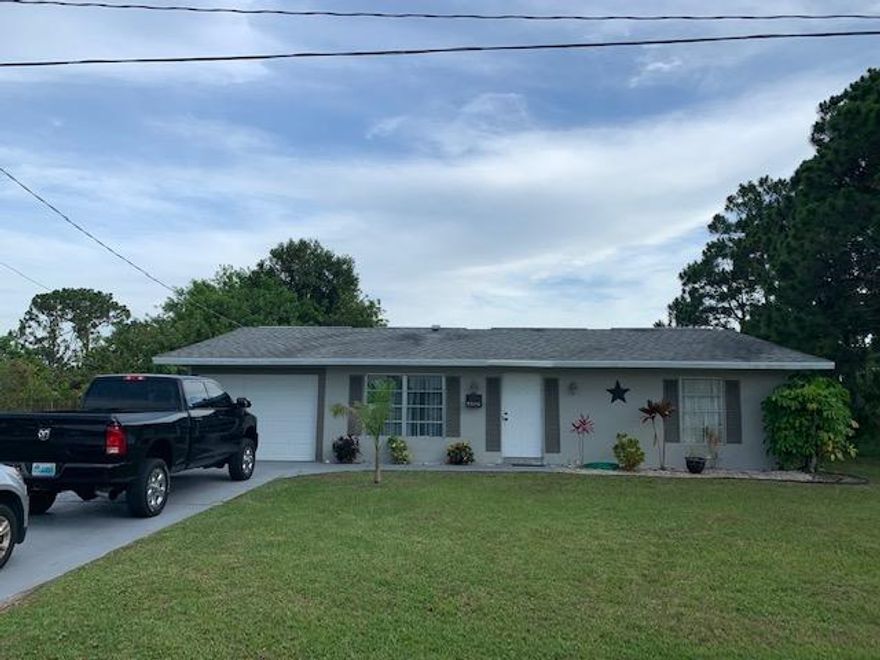 Charming and Spacious 2 bdm/2 bath with a stunning Back Patio for extra living space with sliding glass doors with its 324 sq. ft. enclosure. new hot water heater , and painted inside and out last year    also has large utility shed with electric and a  huge  back yard with new 8 ft. wood privacy fence and fire pit,  ,  .just 2 years old.   vacant lot next door    A/C  was replaced in 2013 and new roof was replaced 12 yrs. ago   1 mile from crosstown parkway,  5 minutes from st. lucie west. this house has the   Old Florida Terrazzo Floors , Don''t let this one pass you by !!!