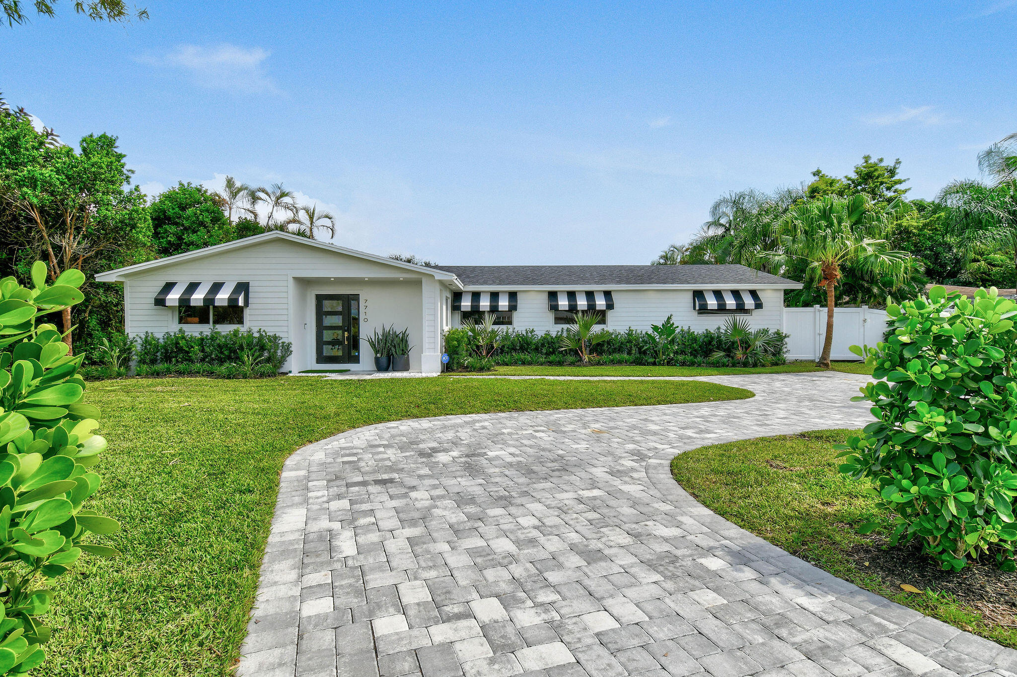 This completely remodeled 2024 masterpiece offers five bedrooms, three bathrooms, and luxurious, turnkey living. The spacious primary suite overlooks the pool and features an oversized walk-in closet with custom cabinetry. A bright Florida room with new impact sliding glass doors connects to the tropical backyard oasis, complete with a sparkling pool and lush landscaping. The open kitchen boasts vaulted ceilings, a large quartz island, and Cafe Series appliances. Updates include two new A/C zones, a tankless water heater, a reverse osmosis water system, modernized plumbing and electrical, a new roof, and a service meter. Custom built-in closets and zoned irrigation complete this move-in-ready home. Use the seller's preferred lender for a $2,000 closing cost credit!