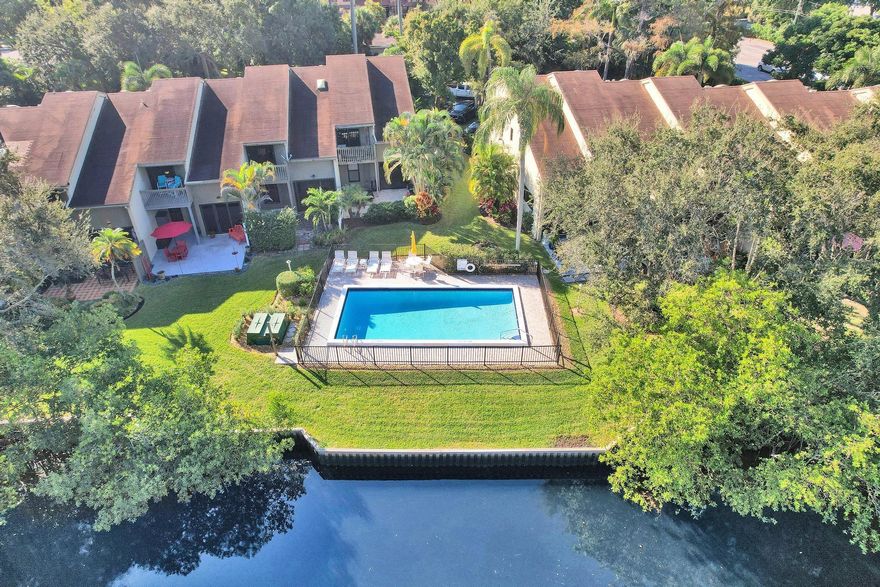 Discover East Fort Lauderdales beautiful 2-bedroom, 2.5-bath corner townhome in the boutique community of Middle River Townhomes of just 10 residences. This light-filled home features soaring vaulted wood ceilings, tile flooring throughout the first floor, and a spacious eat-in kitchen with Granite looking countertops, stainless steel appliances, and a dedicated laundry room. The flexible open space off the living area is ideal for a small office or can be designed as a custom bar, the options are limitless! The elevated dining area overlooks the tranquil flow of the River. The primary suite offers comfort and space with an additional living area, a custom oversized closet & private balcony! Corner unit with new roof, freshly painted exterior, and ready for you.