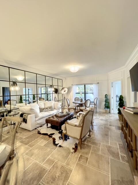 Just completed stunning renovation of this 1 BR/1BA first floor unit. Designer decorated with RH furniture, tumbled travertine flooring and is completely turnkey with everything from an air fryer to beach cruiser. The fully equipped chef's kitchen has SS Viking appliances, cuisinart, vita mix, custom cabinetry and Cesarstone countertops. Bathroom has private guest side entry, porcelain tile and RH vanities with marble tops. Thoughtful details throughout including extensive millwork & mirrored wall make this condo like no other. With beautiful views of the lake and sounds of the fountain it feels like you entered a spa. This spacious unit has loads of natural light, breezy screened in porch, washer/dryer in unit, open kitchen and bike storage. Ocean Trace offers two pools, clubhouse & gym.