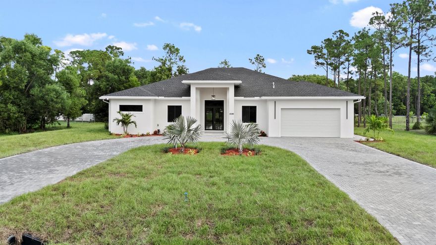 Brand-new CBS home with a two-car garage on 1.15 acres in the heart of Loxahatchee! This 4-bedroom, 3.5-bathroom residence features an open, modern layout with vaulted ceilings, porcelain tile flooring, and impact-rated doors and windows.The gourmet kitchen boasts wood cabinetry, quartz countertops, a large island, oversized pantry, and brand-new stainless steel appliances. The luxurious master suite includes a Roman tub, separate shower, dual vanities, and his-and-her walk-in closets with custom-built shelving.The expansive lot provides exceptional versatility -- allowing you to bring in your boat, RV, trailer, or trucks, raise animals such as horses, or even build a guest house, workshop, or large structure. The backyard is extremely spacious, providing plenty of room for a