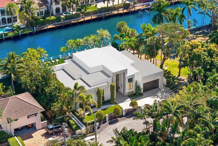 Positioned one home off the point in Fort Lauderdale’s sought after Las Olas Isles, this fully gated modern one-story custom waterfront residence offers 100 feet of water frontage and an exceptional South Florida setting. With no fixed bridges and direct, quick access to the Intracoastal, it is ideal for serious boaters and effortless waterfront living. Built by highly reputable builder Jeff Hendricks, the home showcases 21' ceilings in the great room and 15' ceilings in the kitchen. The well-designed layout includes an office, gym, cabana bath, and a two-car garage with 15' ceilings allowing room for lifts. A roof deck with outdoor shower adds another elevated retreat. Walk to Las Olas Boulevard, dining, shopping, and the beach.