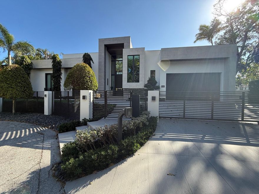 Positioned one home off the point in Fort Lauderdale’s sought after Las Olas Isles, this fully gated modern one-story custom waterfront residence offers 100 feet of water frontage and an exceptional South Florida setting. With no fixed bridges and direct, quick access to the Intracoastal, it is ideal for serious boaters and effortless waterfront living. Built by highly reputable builder Jeff Hendricks, the home showcases 21' ceilings in the great room and 15' ceilings in the kitchen. The well-designed layout includes an office, gym, cabana bath, and a two-car garage with 15' ceilings allowing room for lifts. A roof deck with outdoor shower adds another elevated retreat. Walk to Las Olas Boulevard, dining, shopping, and the beach.