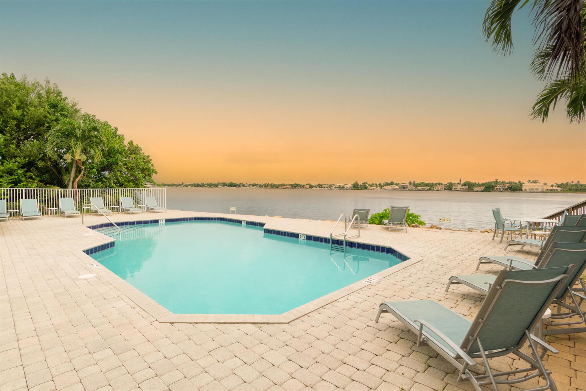 Pristine Townhome is ready for new owners! This gorgeous 3 bedroom home has been updated with white cabinetry and neutral tile downstairs. Meticulously cared for with a coveted 2 car garage. Throw a few lobster tails on the grill and enjoy the huge patio or walk down to the waterfront community pool! You can't beat the view! Only minutes to the beach or world class golf courses! This won't last!