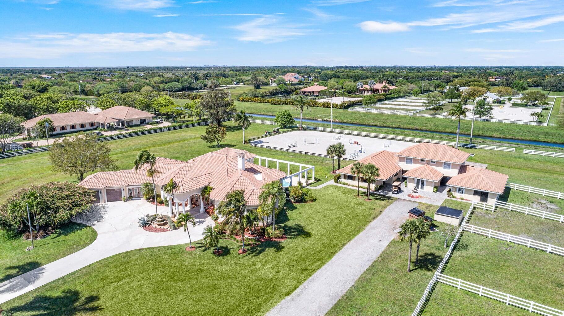 Seasonal Price Breakdown: $10,500 per stall for season. 3 staff quarters priced at $2,000 each per month. Main house $10,000 per month. Ideal season property in gated Palm Beach Point Community!This 5 bedroom home along with a mother in-law suite offers plenty of room to enjoy the 2026 Florida season. Sit pool side and enjoy watching your horses train. The 11 stall barn offers your horses with an off-site oasis within hacking a viewing lounge for clients of the arena, a laundry room, feed room, and tack room. Above the barn there are two separate staff quarters that over look the riding arena. The large riding arena with all weather footing. The 5.5 acre property offers 4 paddocks. Could be available as an annual rent upon request.