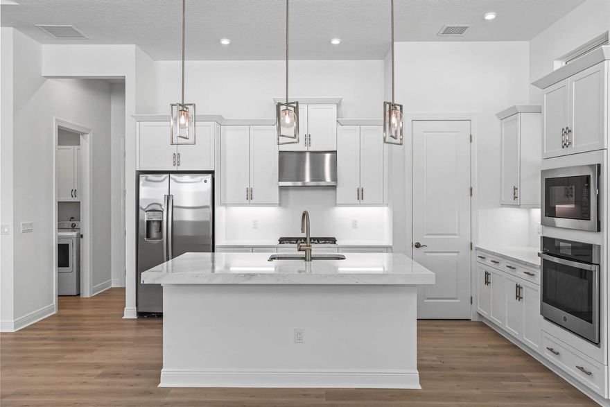 **New Construction** Welcome to the Grace model--an elegantly appointed 3-bedroom, 2-bathroom home perfectly situated near Palm City and Downtown Stuart. The home is settled on homesite with no neighbors behind for enhanced privacy and serene preserve views, and privacy wall pre-plumbed for a summer kitchen, offering future outdoor entertaining. The gourmet kitchen stands out with Cambria Quartz countertops, premium Kitchen Craft cabinetry, a gas GE cooktop, and a stunning 3'' island edge. This home is thoughtfully finished with LED lighting, stylish tray ceilings, and durable laminate flooring throughout, with tile in the bathrooms.