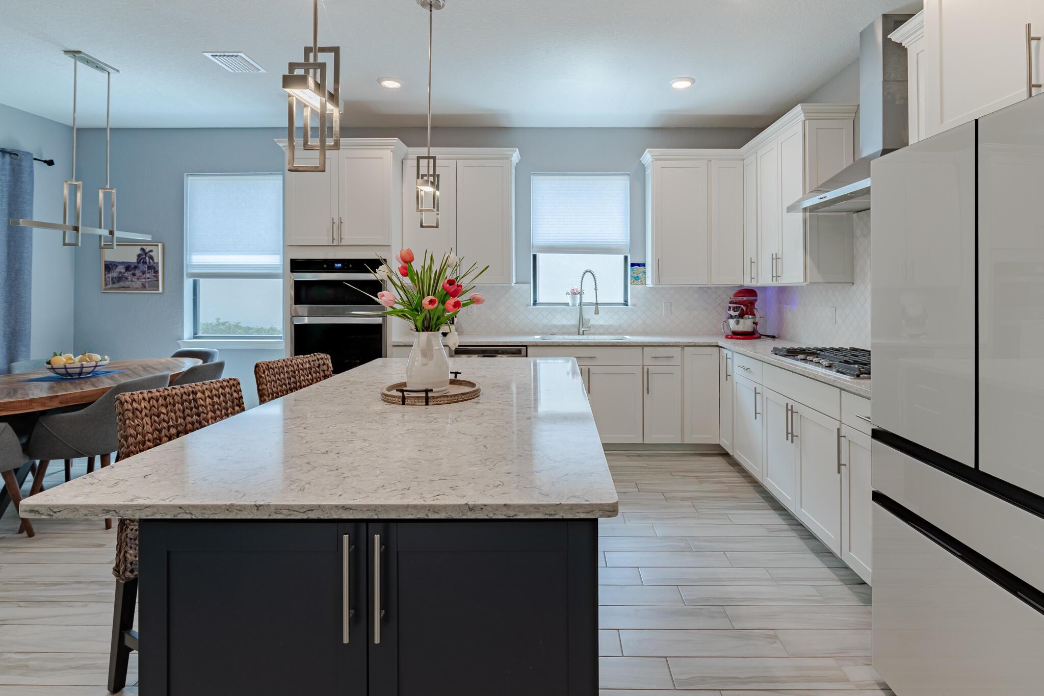 **BEAUTIFUL** 4-bed, 2-bath home spanning 1,849 sq ft is designed for comfort and elegance in gated Veranda Gardens. The heart of the home is the gourmet kitchen featuring a Bespoke refrigerator, KitchenAid GAS cooktop w/hood, wall oven, large island w/convenient end storage, quartz countertops, stylish backsplash, and elegant lighting fixtures. Enjoy peace of mind with full IMPACT glass, as well as blinds, ceiling fans, smooth-finish walls, and 8-foot interior doors. The extended screened lanai invites seamless indoor-outdoor living with private preserve views and space for a pool. Additional upgrades include a brand-new water heater, gutter system, and extended driveway enhancing both functionality and curb appeal. This move-in ready home combines modern luxury with attention to detail.