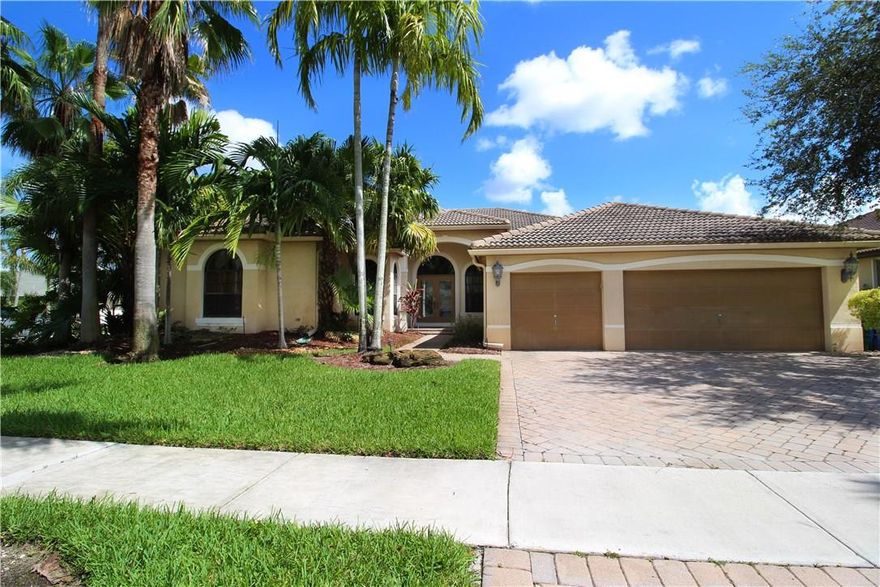 Gorgeous one story home with 5 bedrooms plus a nursery/office/work out in the master bedroom. Beautiful kitchen with rich real wood cabinetry, granite countertops, stainless steel appliances, snack bar, breakfast area and huge pantry. All bedrooms have wood laminate flooring, main areas have tile. Upgraded lighting throughout home. Custom draperies/window treatments in living areas. Backyard is completely private with lush landscaping. Home sits on a large corner lot.  Covered seating around the pool.