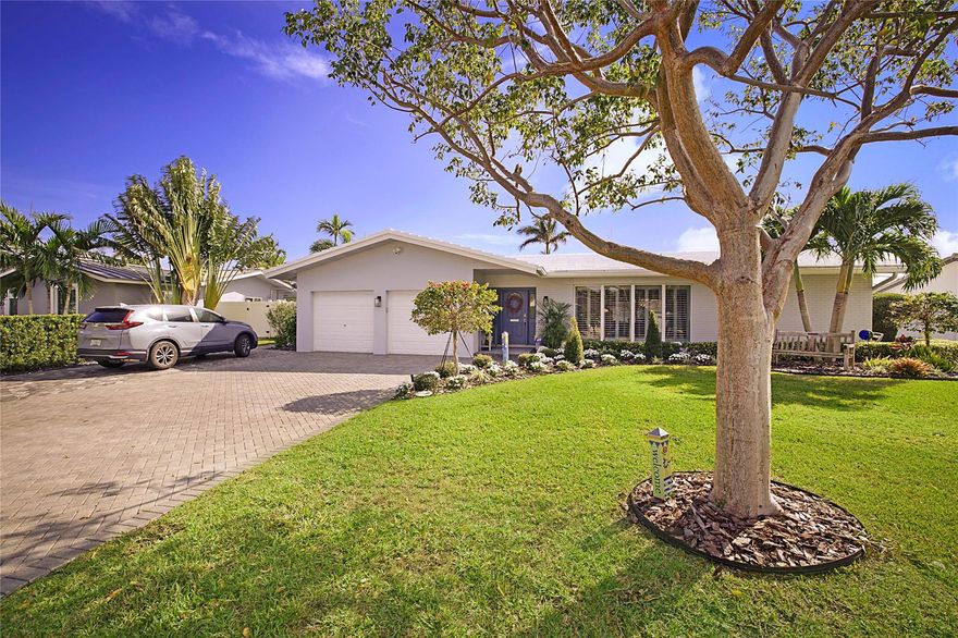 Situated in beautiful Lighthouse Point, this cozy 4 bedroom 3 bathroom home is perfect for embracing the coastal lifestyle. The spacious layout, split floor plan, and multiple living areas also add to the appeal, making the home feel larger and versatile.  The home features extensive updates including impact doors and windows, white plantation shutters, easy care LVP in living areas and bathrooms, freshly painted interior, new lighting, and a complete kitchen remodel with coastal design, new stainless steel appliances, soft close cabinets and quartz countertops. Additionally the AC, hot water heater and pool heater have all been replaced in the last 2 years. Outside the screened in pool and lanai provide a bug free tropical oasis and a large yard with plenty of room for play and storage.