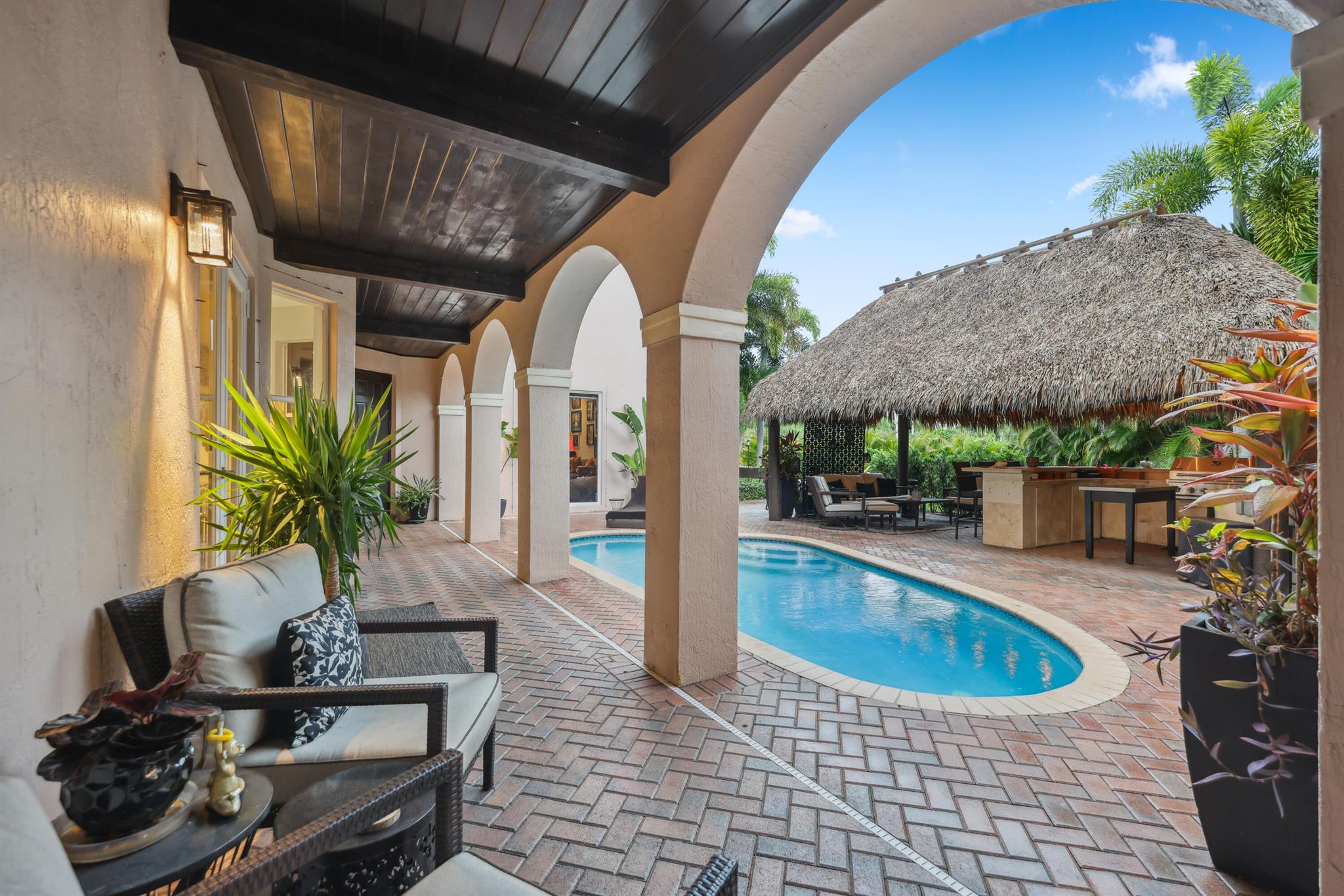 Tucked behind lush landscaping on a private .31-acre corner lakefront lot, this extraordinary 5-bedroom, 4-bathroom residence offers over 5,000 sq ft of sophisticated living space designed for both comfort and grandeur. The main residence features 4 bedrooms and 3 baths, while a separate 1-bedroom, 1-bath guest suite--perfect for in-laws or guests--offers privacy just off the pool.Meticulously renovated with imported finishes from Spain and Italy, the home showcases designer porcelain floors, a floating glass and stainless steel staircase, and a serene primary suite complete with spa bath, free-standing tub, custom walk-in closet, and morning bar.The chef's kitchen is a statement in style and function, featuring Wolf, Sub-Zero, and Monogram appliances, a dramatic waterfall