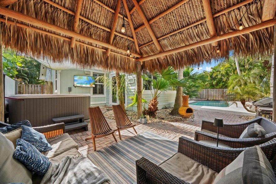 This charming 3 bedroom, 2 bath home is full of character and set in one of Tequesta's most sought-after locations! One of our favorite features is the light-filled sitting area, perfectly positioned to take in views of the pool and tiki hut. Vaulted ceilings create an open, airy feel throughout, while the cottage-style kitchen with a center island adds warmth and style. Both bathrooms have been thoughtfully updated, and hurricane impact windows and doors provide peace of mind. The home has a  2 car garage and an extended driveway provides extra parking for a boat, ideal for embracing the coastal lifestyle. The location truly can't be beat-walk to Constitution Park, Tequesta Recreation Center, local shops, & restaurants, all while being zoned for top-rated Jupiter schools!