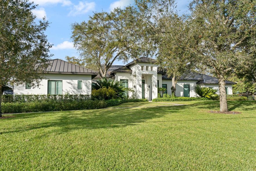 Another Grand Contemporary Design Estate In Sunshine Ranches by Master Custom Home Builder, By His Grace Construction! This classy yet relaxed 1.67-acre estate perfectly blends chic indoor sophistication w/outdoor lush vegetation offering spectacular U-shaped views of the modern resort-style salt-water pool, tanning ledge & stepping niches. Spanning over 9,378 SF of luxurious living space, this amazing home is embellished w/the finest materials & visionary features inc: a super spacious state-of-the-art 10-guest full-grain leather chaise/recliner Media theatre, hi-top counter seating & wet bar ideal for Sports viewing! High-end Wolf/Subzero S/S appli pkg adorned by Kitchen's waterfall quartz center island. 5-car garage w/lifts & upscale Mancave, Sumr kitchen, covered Boat/RV parking & GH!