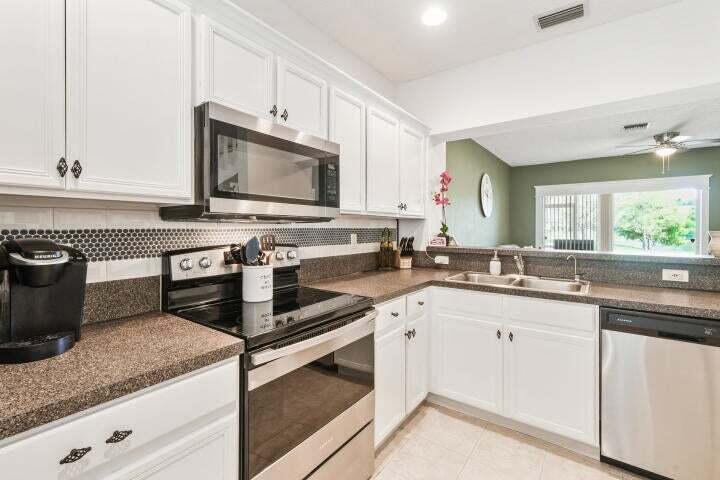 This townhome will not last! Schedule your showing today! It is beautifully updated and well maintained, outfitted with brand new kitchen appliances, newer A/C unit, accordion shutters, wood-like laminate flooring, new fans and light fixtures, freshly painted interior. Experience the privacy of this quaint, gated neighborhood while enjoying the lake views from your living room. Jonathan's Cove offers the residents a community clubhouse, fitness center, pool, children's playground, and beach volleyball. Jonathan's cove is very well located with easy access to major roadways as well as I-95 and the Turnpike.