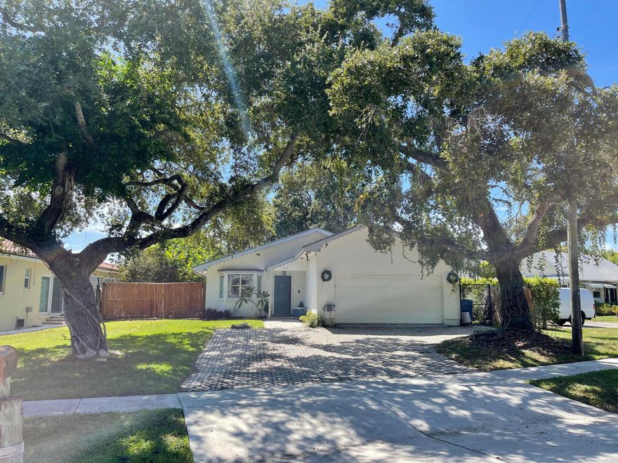 Welcome to 615 S Lake Drive — a rare opportunity to own a uniquely styled coastal home with Intracoastal water views right from the property, perfectly positioned on one of Lantana's most desirable streets. Enjoy the ultimate South Florida lifestyle with the water just across the street, offering daily views of passing boats, sunrises over the Intracoastal, and immediate access to everything waterfront living has to offer. Whether you're seeking a primary residence, vacation retreat, or income-producing investment, this location is unmatched. Inside, the home features an open-concept layout with expansive living and dining areas, abundant natural light, and a flexible floor plan ideal for both everyday living and entertaining. The property's standout appeal lies in its distinctive coastal  character, complemented by major upgrades including a new roof (2023) and impact sliders (2025) that enhance both value and peace of mind while maximizing those water-facing views. Step outside into your own private tropical oasis, where a new pergola overhang with outdoor furniture and fire pit (2024) creates the perfect setting for relaxing after a day on the water, all surrounded by a completely redone backyard with turf and landscape lighting (2025). The lush grounds feature fruit trees, mango trees, mature palms, and oaks, along with dedicated boat storage, making it ideal for boating, fishing, and embracing the full coastal lifestyle. Located just minutes from Lantana Beach, public boat ramps, marinas, and waterfront dining, with easy access to I-95, this property offers a rare combination of water views, location, upgrades, and lifestyle potential. Whether you're looking to live, invest, or create a high-performing short-term rental, 615 S Lake Drive delivers a true Intracoastal living experience you don't want to miss.