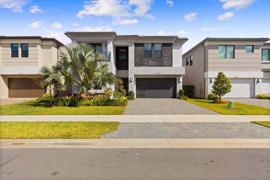 Luxury Modern Polynesia Model | Half Lake View | Brand New Designer Interior | Pool & Spa Coming Soon. Stunning Polynesia model located in the prestigious Lotus Palm community. This beautifully upgraded 5-bedroom, 7-bath residence features soaring 22-foot ceilings, custom designer accent wall, modern glass staircase, and high-end contemporary lighting throughout. The home offers an open-concept layout, expansive living areas, and a clean modern aesthetic rarely found in the community. Located in one of Boca Raton's most sought-after gated communities with resort-style amenities including clubhouse, fitness center, tennis courts, and more.
Enjoy partial lake views from your private backyard with a brand-new luxury pool & spa is currently under construction and scheduled for completion