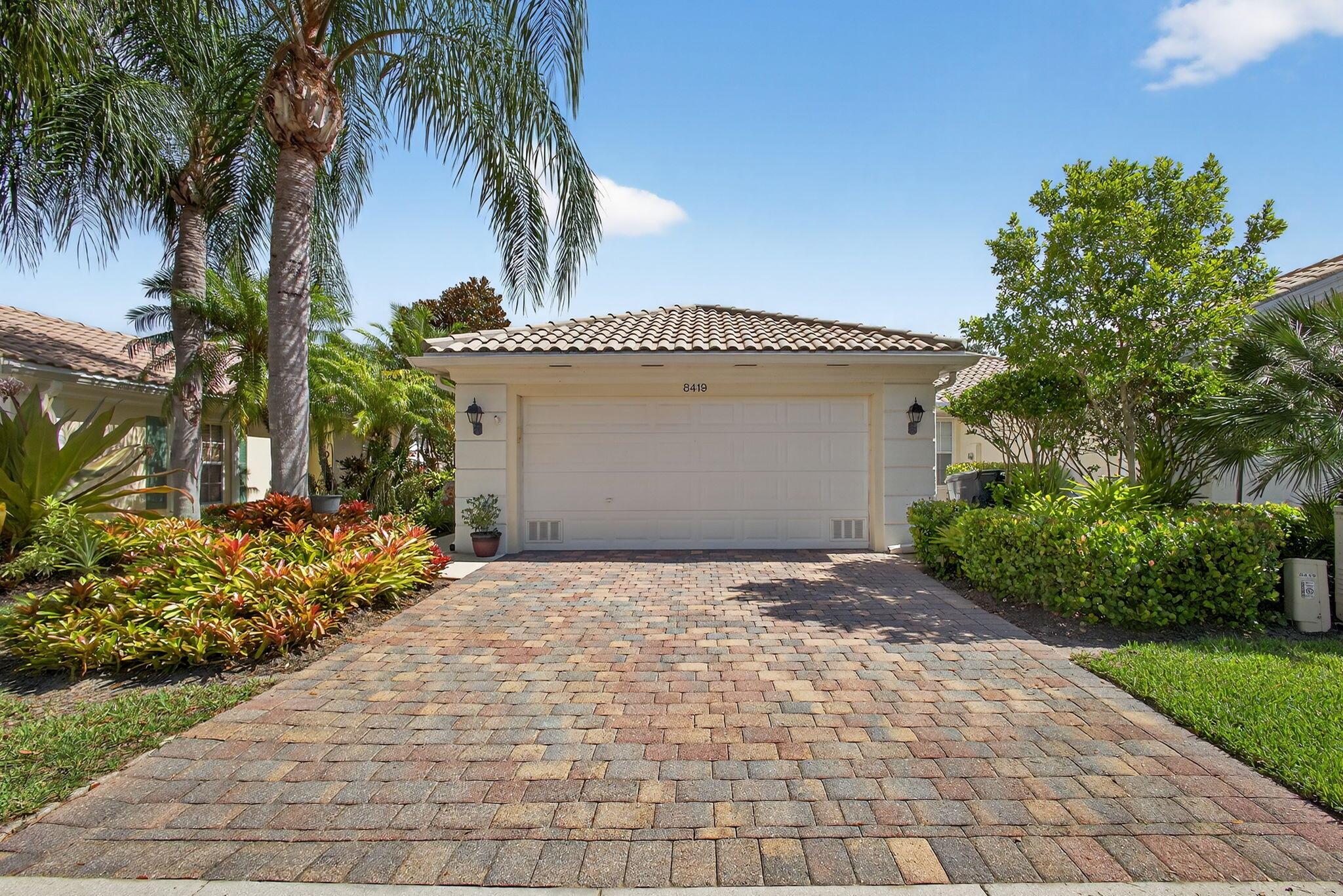 Welcome to 8419 St Johns Court, located in the highly desirable, gated resort-style community of VillageWalk of Wellington. This beautifully maintained 2-bedroom, 2-bath villa sits just before the cul-de-sac, offering a peaceful setting with stunning lake views.Designed for comfort and privacy, the split bedroom floor plan features a spacious primary suite overlooking the backyard and lake, complete with a walk-in closet with built-ins and an en-suite bath with double sinks. The guest suite also offers a large walk-in closet with built-in shelving and a full bath nearby. The screened-in lanai provides the perfect spot to relax and enjoy your morning coffee while taking in the tranquil water views.Built by DiVosta with solid poured concrete construction, this home includes accordion