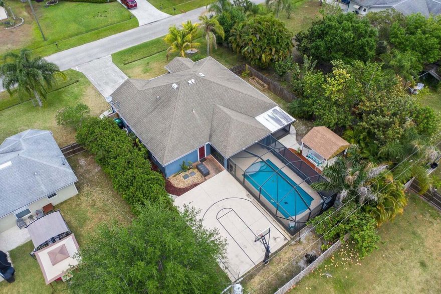 Fantastic Location
 This spacious CBS POOL HOME is perfectly situated near the highly sought-after area of Crosstown Parkway, offering convenient access to the Turnpike and I95. Step into your own private oasis as you enter the fenced-in backyard, complete with a stunning sparkling screened-in pool that invites you to take a refreshing dip on those hot summer days. The backyard also boasts a beautiful pavilion area, perfect for hosting weekend barbecues or enjoying a friendly game of basketball on the half-court. After a long day, unwind in your very own sanctuary - a spacious covered lanai featuring an above-ground spa, where you can soak away all your cares and worries!