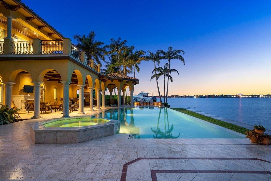 Sunsets and Serenity...Enjoy 180 degrees of private and amazing wide water views! Over 230 ft of waterfront will accommodate a 100' vessel with protected dockage. Minutes to the ocean via the palm beach inlet with no fixed bridges. Enjoy outdoor oversized shaded patios to protect you from the hot Florida sun in the summer. Outside summer kitchen and a 50' Infinity pool to enjoy all year round.

This spectacular custom home built in 2008 with 6,621 sqft of living. Grand size dining, breakfast nook, family seating around one of two center islands opens to the family room. Private study, Large separate living room with French doors for privacy. 4 bedrooms each with a private en suite bath.

Elevator to the second level master suite with a private balcony with amazing water views. A multi -purpose bonus area can serve as a nursery, fitness, etc.. Custom built-in closets with copious storage, and a private master laundry attached to the master closet.

A timeless chef's kitchen with two spacious center islands to gather with family and friends all complimented with high end granite counters, custom lighting top of the line appliances. Double sub-zero refrigerator, Wolfe 8 burner gas stove, double ovens. A butler's pantry and built-in custom cabinets offer a tremendous storage for entertaining in mind.

Other features include Pecky Cypress beams, custom moldings and hand carved coral stone fireplaces, built in beverage center with ice maker and beverage cooler. Icynene foam insulation, hurricane impact windows, fire sprinkler system, 75 Piling and Grade beam slab . Plus so much more....

Minutes to Palm beach and the gardens best restaurants and shopping.