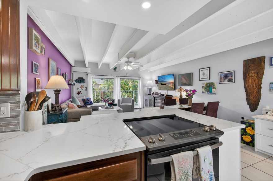 Maximization of space is a defining characteristic of this thoughtfully designed waterfront 1/1 at Tropicana Gardens. The bright kitchen offers double or triple the counterspace of comparable units. The countertops are white quartz, with matching stone in the workspace setup. The backsplash is fresh & creates a harmonious contrast with the original wood cabinets from 1958, restored & beautifully maintained. The desk area is great for someone working from home or just using the computer. For someone valuing additional kitchen space, it could be used in that capacity as well. Enjoy an Intracoastal view from the balcony. There is impact glass throughout; wood flooring in the living area & bedroom; tile in the kitchen. Great natural light is complemented by recessed lighting, track lighting & the ceiling fan lights. An updated bathroom features an LED-framed mirror & modern vanity. The bedroom features a neat vanity with chair. All units come with a large, separate storage locker & 1 assigned parking spot. Tropicana Gardens is a well-maintained 55+ community with a heated pool on the Intracoastal. The building is past Milestone Inspections & fully reserved. It's a quiet community but also offers social events. There is an elevator, common laundry & bike storage. The location is a major part of the allure. There is ocean access across the street at Lantana Beach. Also, great proximity to: The Eau Resort; Dune Deck Café; Plaza del Mar Shopping Center with Publix & restaurants Thaikyo & Art Basil; Lantana Nature Preserve. The sidewalks are bustling with walkers, joggers, bikers & shoppers. This is island living!