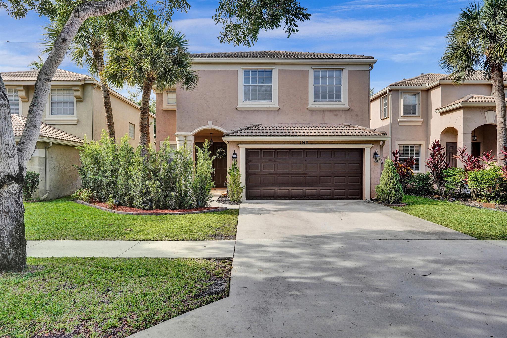 Located on a quiet, tree-lined street and surrounded by lush, mature landscaping, this stunning 5-bedroom Florida home offers breathtaking golf and water views. Imagine unwinding in your expansive, fenced-in backyard after a long day, soaking in the peaceful ambiance and picturesque sunsets. The freshly painted interior features an updated kitchen with granite countertops, modern cabinetry, and sleek stainless steel appliances. Downstairs boasts durable tile flooring, while engineered wood adds warmth and elegance upstairs. The spacious family room flows seamlessly into an elegant formal living area that can flex as a playroom, home office, or bonus space to suit your needs.Upstairs, the massive primary suite is flooded with natural light and showcases tranquil water views, along