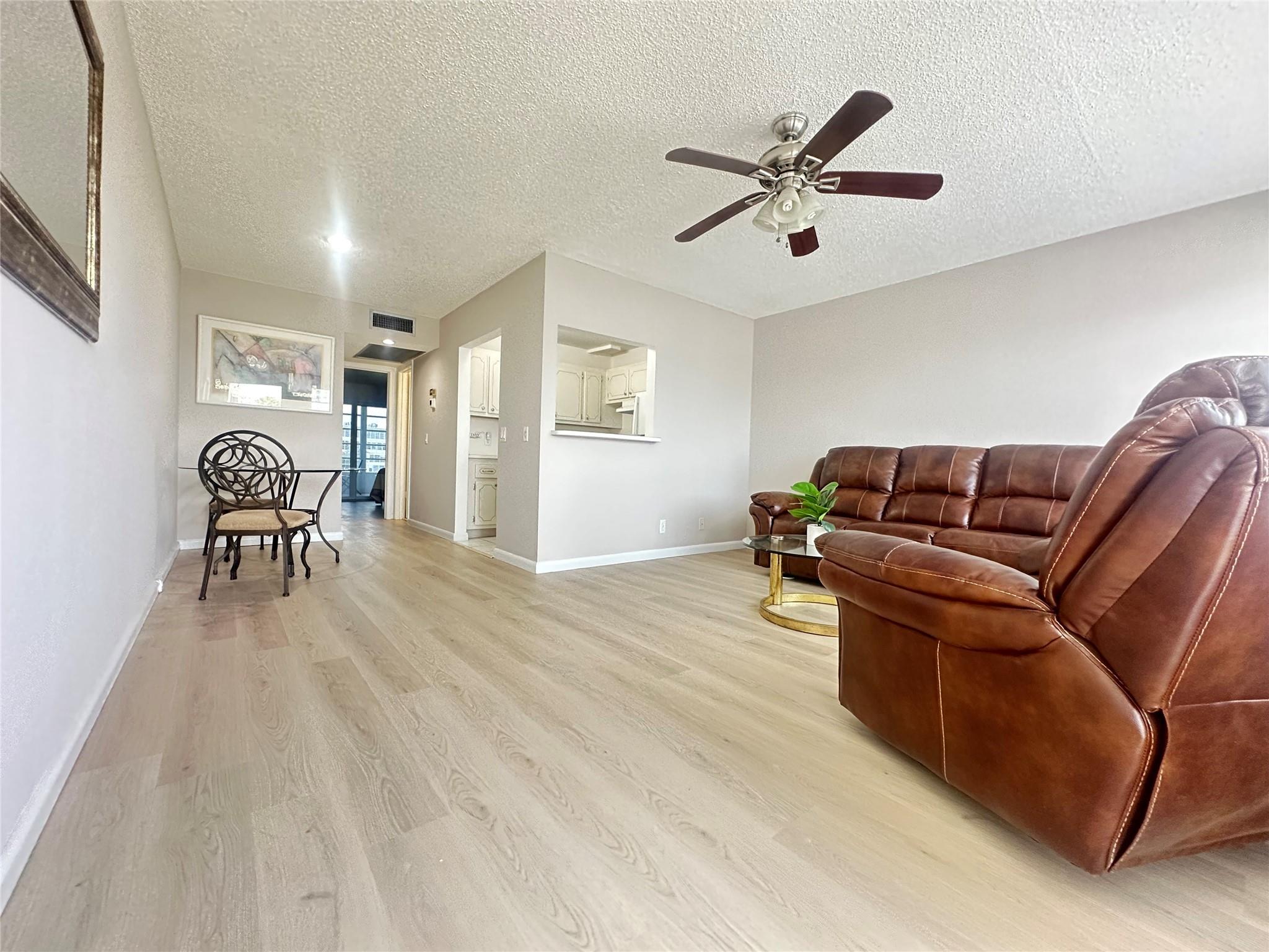 GORGEOUS WATER VIEW! This clean & bright 1 bed, 1 bath condo on the 2nd flr is priced right and READY FOR YOU to enjoy Florida living at its best! Features include new waterproof vinyl floors throughout, fresh paint, new sliding glass doors w/built-in blinds & smooth bedroom ceiling w/recessed lighting! Kitchen has white appliances (NO DOME), & the bathroom offers a tub/shower combo w/glass doors. Unit comes partially furnished—living room sofa & recliner are electric! Enjoy the stunning lake view from your 8 Ft. enclosed patio. Conveniently located near elevator & laundry! Well-maintained bldg. w/full reserves, BRAND NEW ROOF & 2 elevators! Resort-style 55+ gated community w/24-hr security, free bus, theatre, library, fitness center, billiards, pools, tennis, pickleball & MORE!