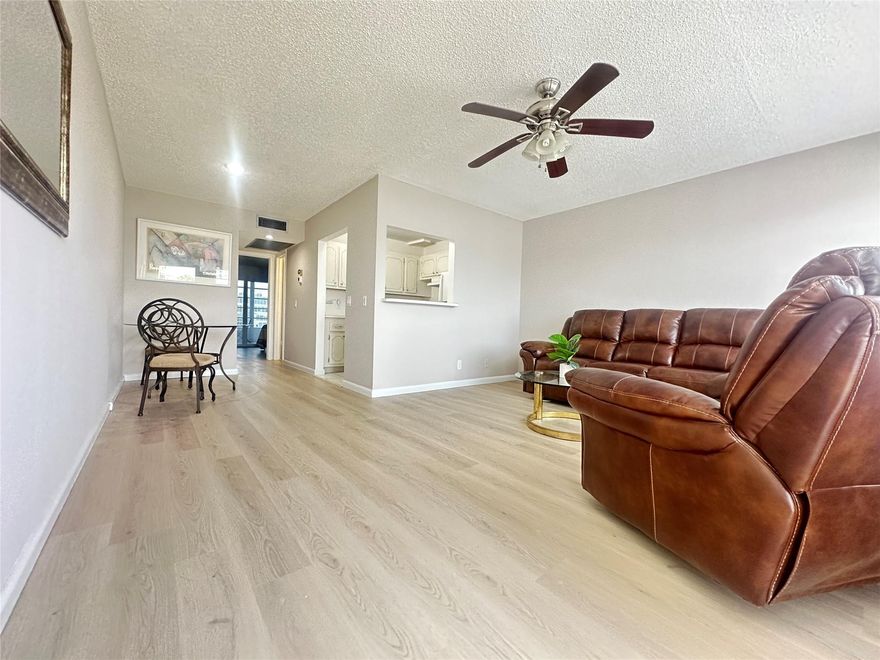GORGEOUS WATER VIEW! This clean & bright 1 bed, 1 bath condo on the 2nd flr is priced right and READY FOR YOU to enjoy Florida living at its best! Features include new waterproof vinyl floors throughout, fresh paint, new sliding glass doors w/built-in blinds & smooth bedroom ceiling w/recessed lighting! Kitchen has white appliances (NO DOME), & the bathroom offers a tub/shower combo w/glass doors. Unit comes partially furnished—living room sofa & recliner are electric! Enjoy the stunning lake view from your 8 Ft. enclosed patio. Conveniently located near elevator & laundry! Well-maintained bldg. w/full reserves, BRAND NEW ROOF & 2 elevators! Resort-style 55+ gated community w/24-hr security, free bus, theatre, library, fitness center, billiards, pools, tennis, pickleball & MORE!