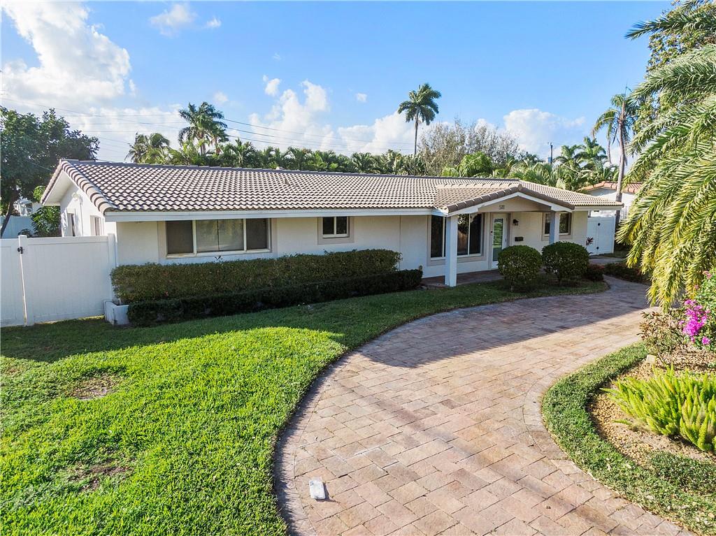 Investors Dream! Fully Remodeled Home in Lighthouse Point!! Motivated Seller!! Open floor plan with split bedrooms, a large covered screened patio overlooking the heated salt water pool, deck and fenced yard. Great for entertaining! Upgrades include: 2015 roof, impact windows and doors throughout, wood look tile flooring throughout, complete new bathrooms, high end fixtures, new doors and moldings, and new kitchen with quartz countertops, cabinets and ss appliances. 2017 includes a new circular paver driveway, washer and dryer, tankless water heater, new landscaping and sprinklers with a rust inhibitor, electric was done with Cat 5 and Cat 6 cables with WiFi enabler, and has security cameras. 2021 includes new pool pump, salt water system and pool heater. Everything was done with permits!