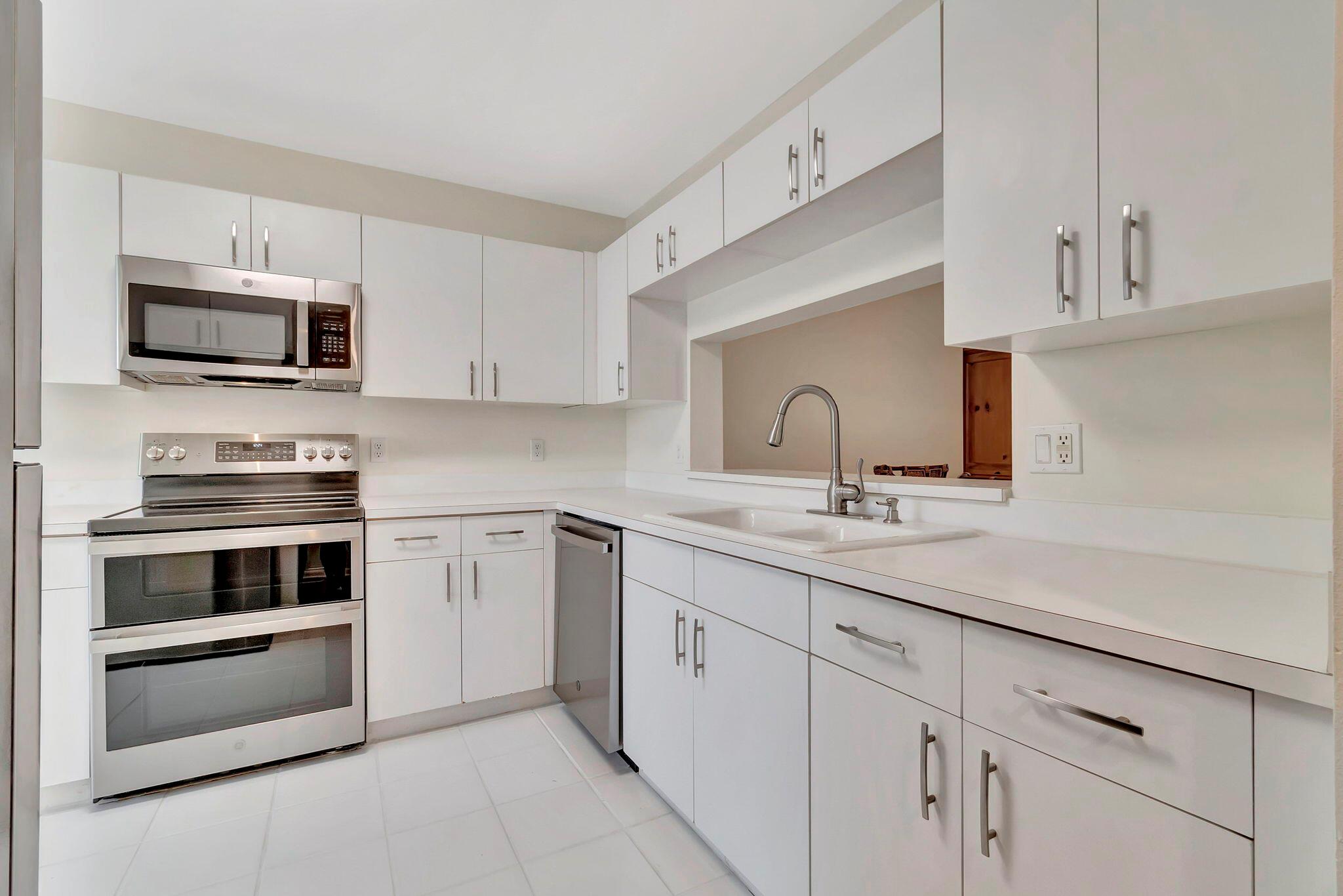 Welcome to living at Lucerne Lakes in Fairway Club (a 55+ community)! This beautiful 2BR 2BA Penthouse Condo (no upstairs neighbors!). Enjoy serene living with beautiful tree-lined views from a glass and screen enclosed patio. Step inside to discover updated floors and a spacious layout, perfect for entertaining guests or relaxation. Experience resort-style amenities including a community pool, clubhouse with entertainment options, gym, tennis courts, billiards, and card rooms. Additionally, residents enjoy access to a clubhouse with a main swimming pool, sauna, steam room, community room, and card room.